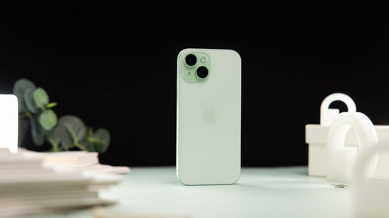 Apple iPhone 15 standing on a table highlighting the back cover Apple iPhone 15 standing on a table highlighting the back cover