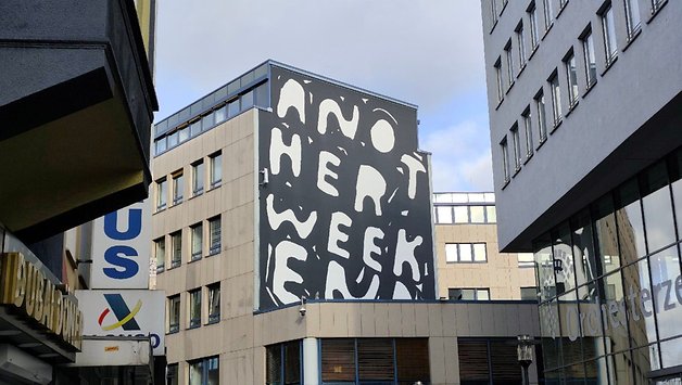 A building with a mural that has some text on it.